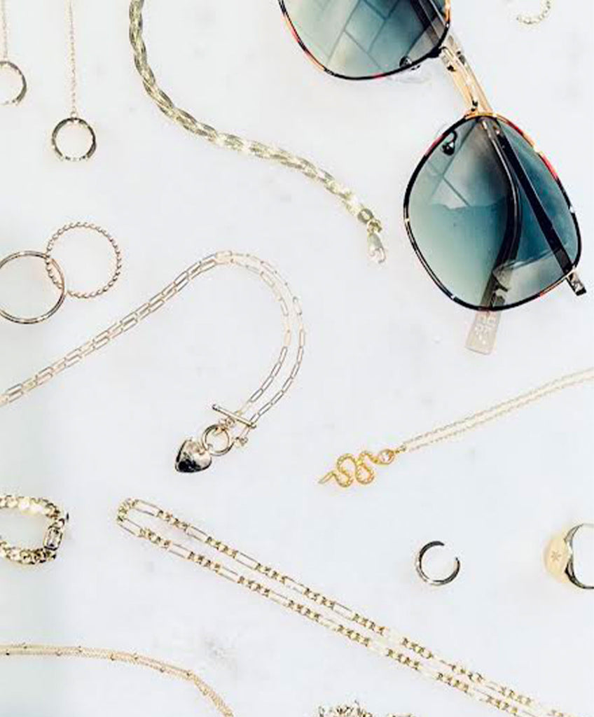 various accessories like necklaces, rings, earrings, and sunglasses from Jean Theory: